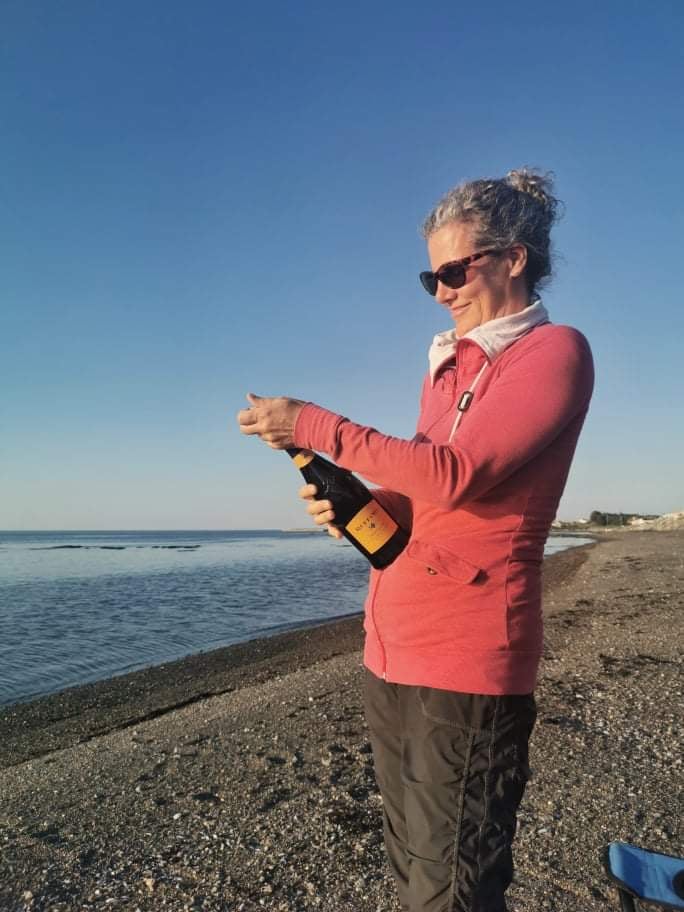 popping open a bottle of bubbly on the beach