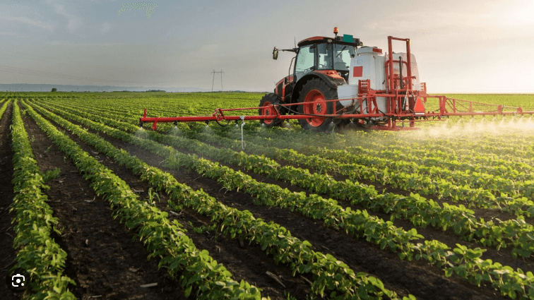 farmer spraying crop with herbicide